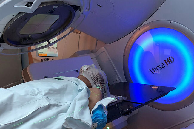Woman receiving radiotherapy.