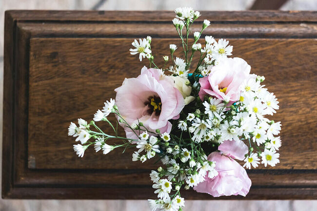 Coffin with flowers on top.
