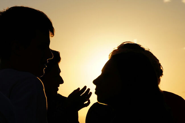 Silhouettes of people talking.