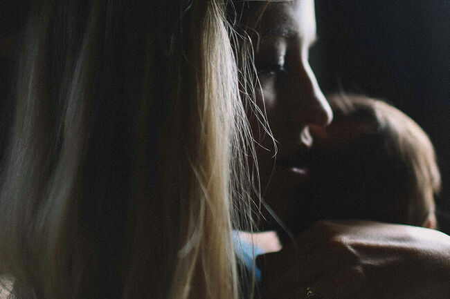 Mother with child in dark lighting