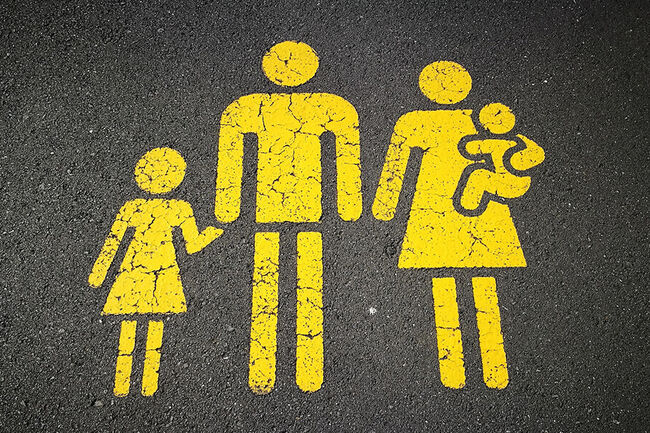 Family drawn in yellow on the asphalt