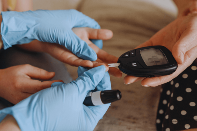 Image of a person measuring blood sugar in a patient