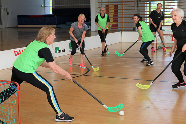 Women playing hockey.